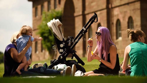 Family sat in the grounds of Berrington Hall, Herefordshire